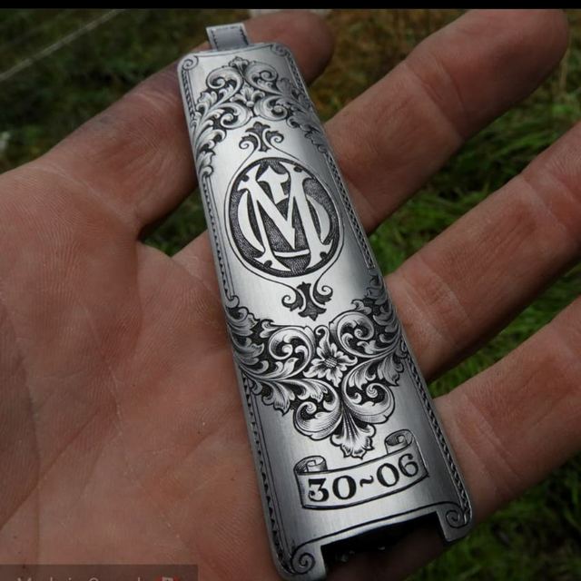Rifle floorplate, hand-engraved with scrollwork and a monogram
