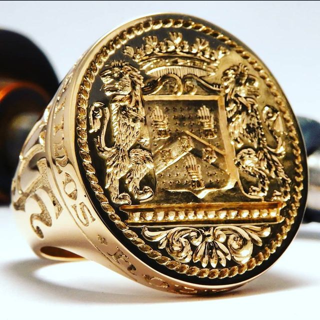 Large gold signet ring, deep-engraved with a coat of arms and lion supporters
