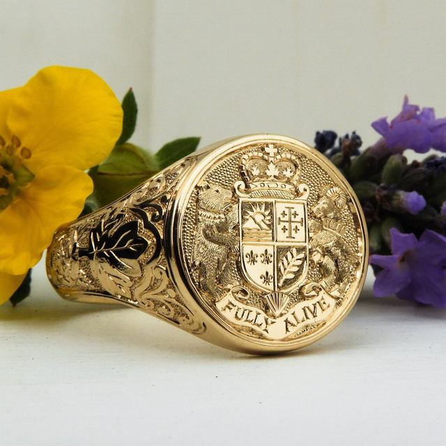 Gold signet ring hand-engraved with a family crest and motto